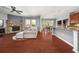 Open-concept living room with stone fireplace and hardwood flooring at 2881 Terra View Sw Dr, Lilburn, GA 30047
