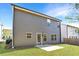 Back exterior of home features a small yard and door with a concrete patio area at 3314 Tiara Cir, Atlanta, GA 30311