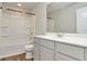 A well-lit bathroom featuring a tub, shower, and vanity with modern fixtures at 3314 Tiara Cir, Atlanta, GA 30311