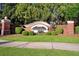 Cascade Parc community entrance with brick pillars, a decorative sign and lush green landscaping at 3314 Tiara Cir, Atlanta, GA 30311