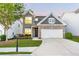 Charming two-story home featuring a brick accent, well-manicured lawn, and attached two-car garage at 3314 Tiara Cir, Atlanta, GA 30311