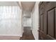 Inviting hallway features hardwood floors, neutral paint, and elegant marble-patterned accent wall at 3314 Tiara Cir, Atlanta, GA 30311