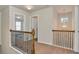 Hallway with wood and wrought iron banister, carpet and view of the stairway and chandelier at 3314 Tiara Cir, Atlanta, GA 30311