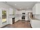 Bright kitchen with white cabinets, granite countertops, stainless steel appliances, and hardwood floors at 3314 Tiara Cir, Atlanta, GA 30311
