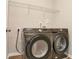 Laundry room complete with a washer, dryer, and overhead shelving at 3314 Tiara Cir, Atlanta, GA 30311