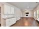 Spacious living area with hardwood floors, recessed lighting, and updated kitchen featuring stainless steel appliances at 3314 Tiara Cir, Atlanta, GA 30311