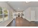 Open-concept living area with hardwood floors, white walls, and stainless-steel appliances in the kitchen at 3314 Tiara Cir, Atlanta, GA 30311