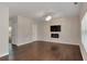 Stylish living room with hardwood floors, contemporary lighting, TV and fireplace at 3314 Tiara Cir, Atlanta, GA 30311