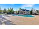 Community pool with a bath house set amongst mature trees with bright blue skies overhead at 3314 Tiara Cir, Atlanta, GA 30311