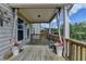 Relax on this covered wooden deck, enhanced with decorative flowers and stylish privacy curtains at 4349 Northmark Ln, Buford, GA 30518