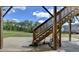 View of stairs leading to the upper deck and backyard from the lower covered patio at 4349 Northmark Ln, Buford, GA 30518