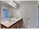 Bathroom featuring double sinks, granite countertops and a large mirror with a door to the side at 4349 Northmark Ln, Buford, GA 30518