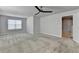 Spacious bedroom features plush carpeting, natural light from a window, and a modern ceiling fan at 4349 Northmark Ln, Buford, GA 30518