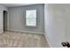 Carpeted bedroom with neutral paint and window allowing natural light at 4349 Northmark Ln, Buford, GA 30518