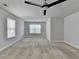 Spacious bedroom features plush carpeting, natural light from multiple windows, and a modern ceiling fan at 4349 Northmark Ln, Buford, GA 30518