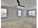 Spacious bedroom features plush carpeting, natural light from multiple windows, and a modern ceiling fan at 4349 Northmark Ln, Buford, GA 30518