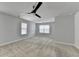 Spacious bedroom features plush carpeting, natural light from multiple windows, and a modern ceiling fan at 4349 Northmark Ln, Buford, GA 30518