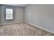 Bedroom with window providing natural light and beige carpet flooring at 4349 Northmark Ln, Buford, GA 30518