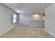 A wide-angle view of the bonus room with neutral carpet, white trim, and a window at 4349 Northmark Ln, Buford, GA 30518