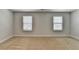 A bright bonus room with neutral carpet, multiple windows, and simple white molding at 4349 Northmark Ln, Buford, GA 30518