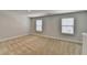 Large bonus room space with neutral carpeting and multiple windows allowing for plenty of natural light at 4349 Northmark Ln, Buford, GA 30518