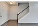 Bright entryway featuring hardwood floors, stairs with white railings, and a white front door at 4349 Northmark Ln, Buford, GA 30518