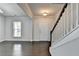 Inviting entryway with hardwood floors, a staircase with a white railing, and a front door with sidelights at 4349 Northmark Ln, Buford, GA 30518