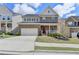 Beautiful two-story home with a brick facade, two-car garage, and a welcoming front porch and landscaped yard at 4349 Northmark Ln, Buford, GA 30518