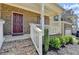 Inviting front porch featuring brick steps, white railing, and lush landscaping leading to a front door at 4349 Northmark Ln, Buford, GA 30518
