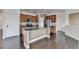 Open-concept kitchen boasts stainless steel appliances and a granite island at 4349 Northmark Ln, Buford, GA 30518