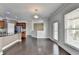 Living and kitchen area featuring hardwood floors, granite countertops, stainless appliances, and access to a balcony at 4349 Northmark Ln, Buford, GA 30518