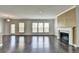 Open-concept living area with fireplace and large windows; ideal for Gathering gatherings at 4349 Northmark Ln, Buford, GA 30518