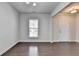 Open living room with hardwood floors, natural light, and neutral wall color at 4349 Northmark Ln, Buford, GA 30518