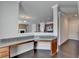 Angle view of the office space featuring granite countertops, wood floors, and open sight lines to the rest of the home at 4349 Northmark Ln, Buford, GA 30518