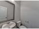 Stylish powder room with modern fixtures and a decorative mirror at 4349 Northmark Ln, Buford, GA 30518