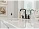 Bathroom sink showcases a sleek white countertop, matte black faucet, and neutral décor at 440 Carrera Ln, Acworth, GA 30102