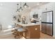 Kitchen island featuring stainless steel appliances, a breakfast bar, and stylish lighting at 440 Carrera Ln, Acworth, GA 30102