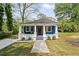 Charming blue cottage with a welcoming front porch and well-manicured lawn at 531 Roy Sw St, Atlanta, GA 30310