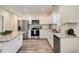 Bright kitchen features granite countertops, stainless steel appliances, and white cabinets at 531 Roy Sw St, Atlanta, GA 30310