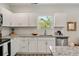 Bright kitchen features granite countertops, stainless steel appliances, and white cabinets at 531 Roy Sw St, Atlanta, GA 30310