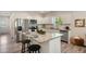 Bright eat-in kitchen features an island, granite countertops, stainless steel appliances, and white cabinets at 531 Roy Sw St, Atlanta, GA 30310