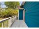 Side view of deck shows the exterior of the home with blue siding and white trim at 531 Roy Sw St, Atlanta, GA 30310
