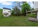 Expansive backyard with lush lawn, mature trees, wood deck, and patio offers plenty of space at 131 Magazine St, Dallas, GA 30157