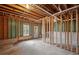 Unfinished basement with concrete floor, exposed wood framing, and a window, offering a customizable space at 131 Magazine St, Dallas, GA 30157