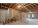 Unfinished basement with exposed beams, stairs, and natural light at 131 Magazine St, Dallas, GA 30157