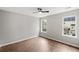 Serene bedroom with hardwood floors, two windows providing natural light, and neutral decor at 131 Magazine St, Dallas, GA 30157