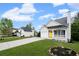 Cozy single-story home with a bright yellow door, front porch, attached garage, and green lawn at 131 Magazine St, Dallas, GA 30157