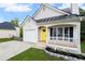 Charming single-story home featuring a yellow front door, inviting front porch, and attached garage at 131 Magazine St, Dallas, GA 30157