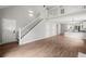 Bright open-concept living space with stairs to loft, with luxury vinyl plank flooring and natural light at 131 Magazine St, Dallas, GA 30157