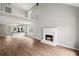 Spacious living room with a fireplace, open to the kitchen and loft above, bathed in natural light at 131 Magazine St, Dallas, GA 30157